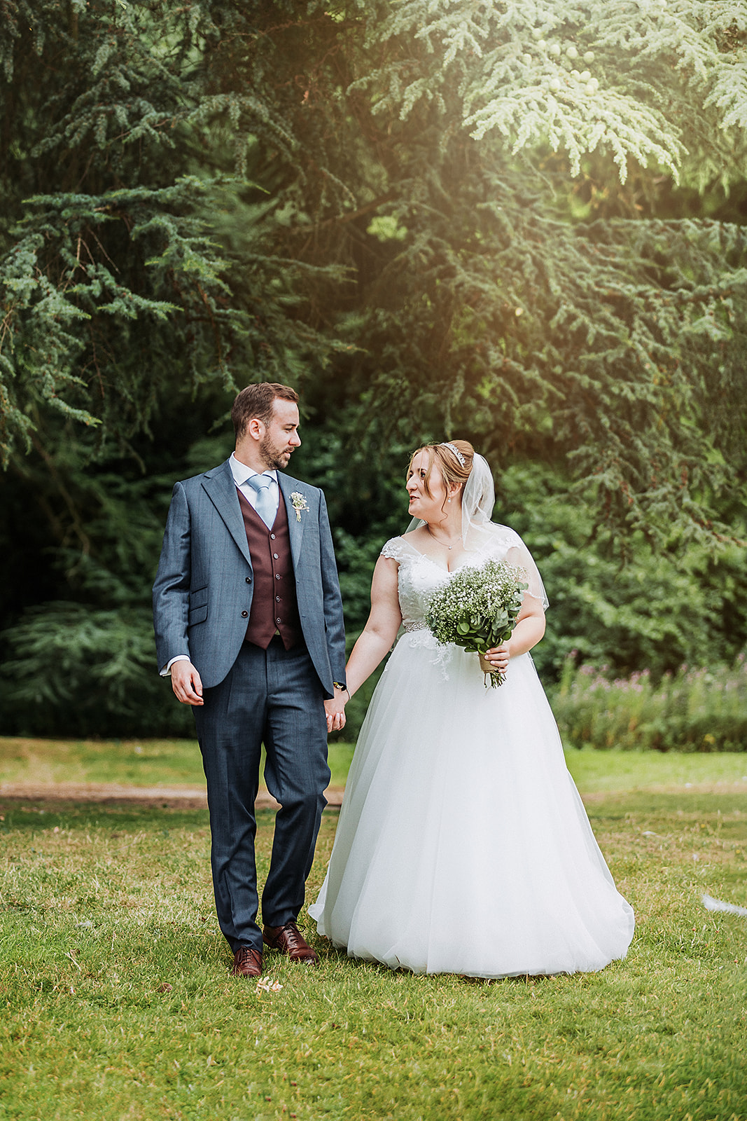 Bride and groom walking the grounds of Pendley Manor, Tring. Wedding Photo by Perfect Memories photography