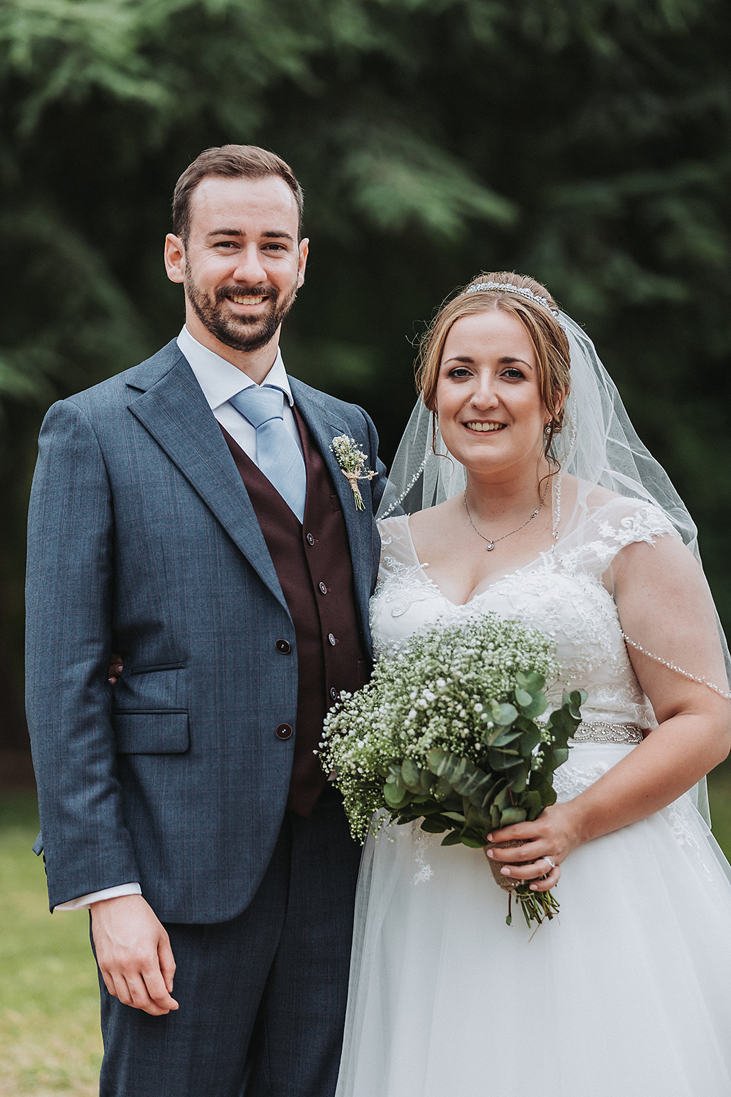 Bride and groom smiling at Pendley Manor, Tring. Wedding Photo by Perfect Memories photography
