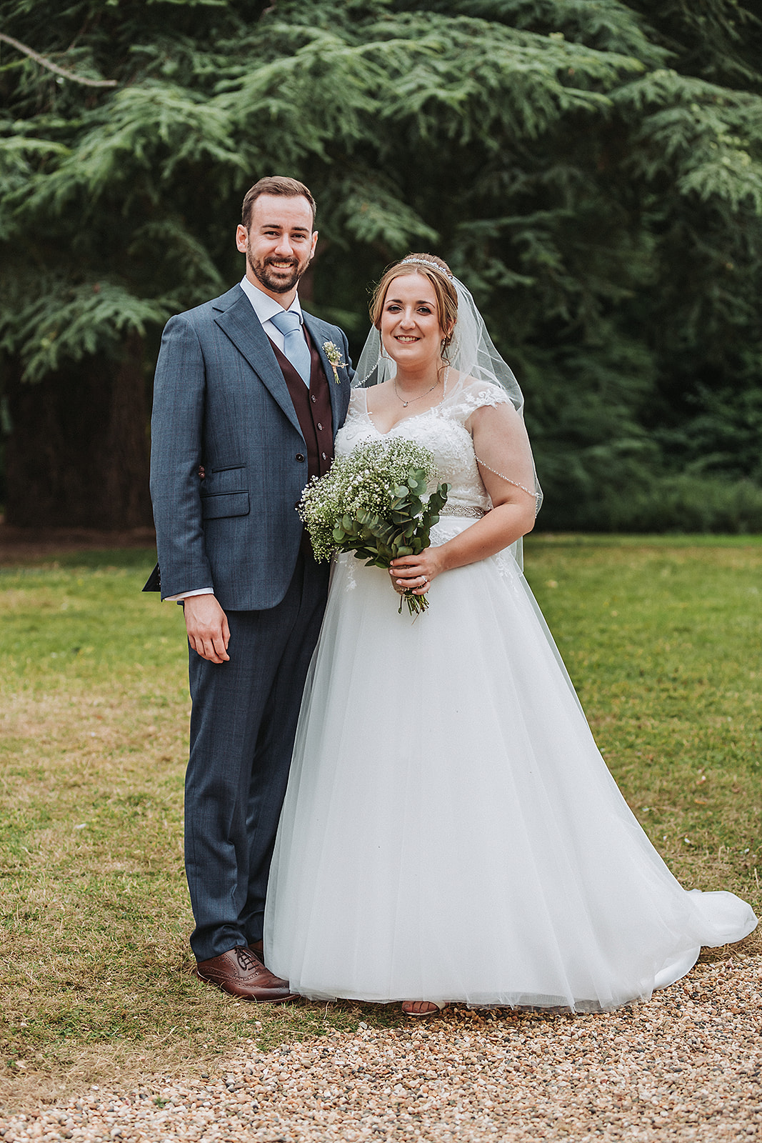 Bride and groom smiling at Pendley Manor, Tring. Wedding Photo by Perfect Memories photography