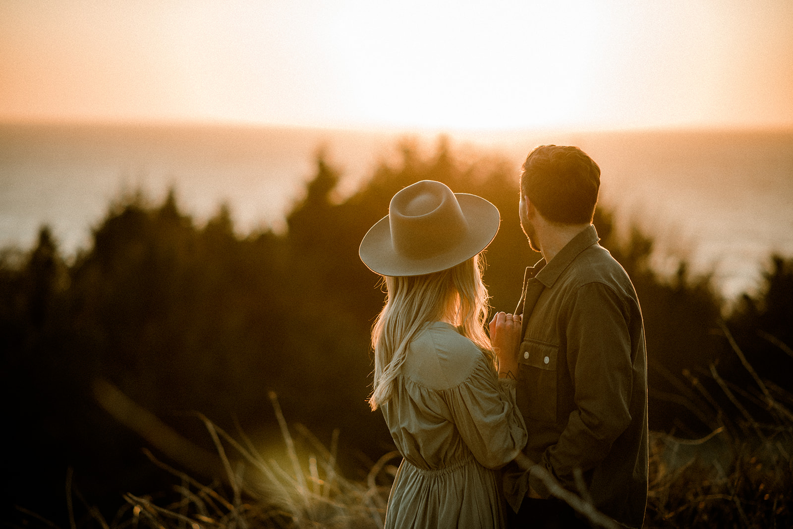 A couple at sunset in golden hour holding each other at their Northern Oregon Coastal Engagement