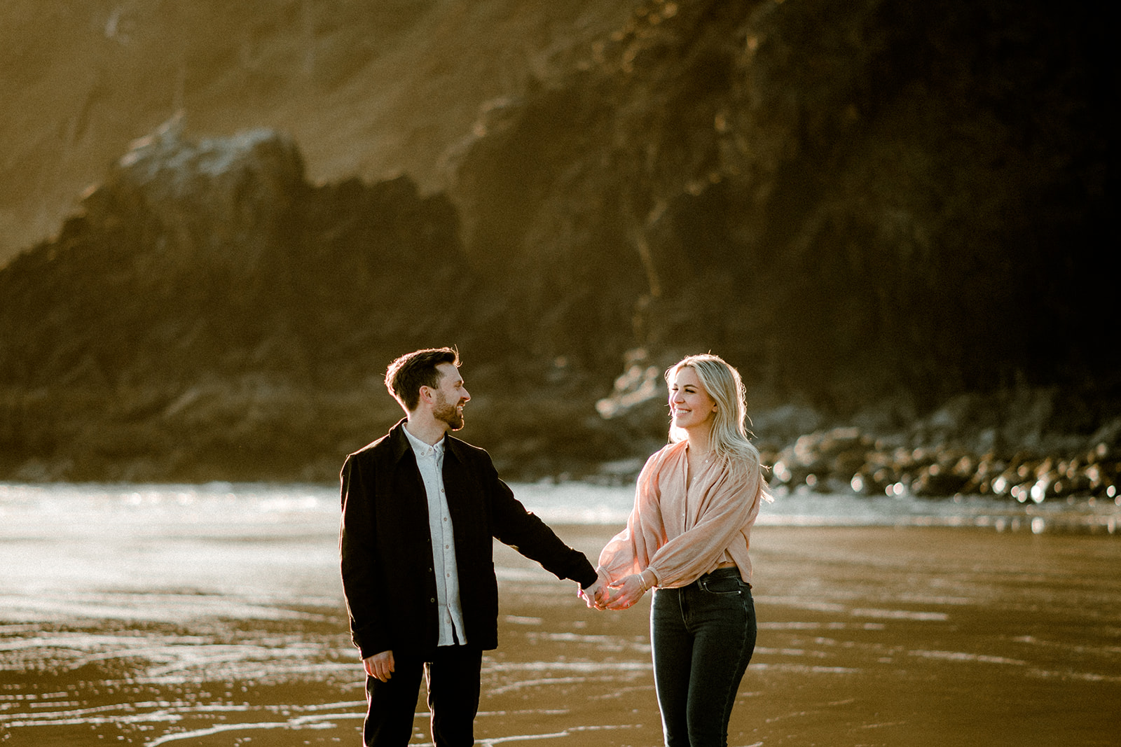A couple posing in the sand near Cannon Beach at their Northern Oregon Coastal Engagement