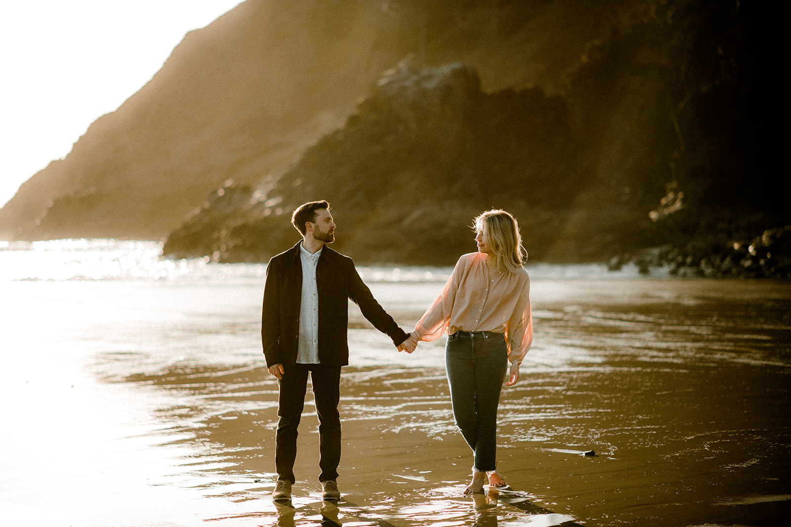 A couple posing in the sand near Cannon Beach at their Northern Oregon Coastal Engagement
