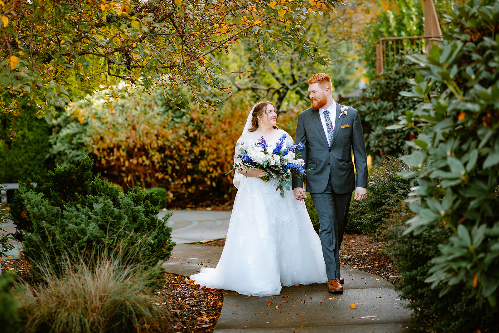 Couple walks in botanical gardens at their wedding
