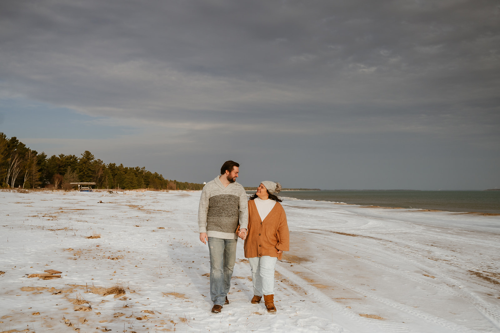 A couple who had engagement pictures taken on the shores of Lake Huron