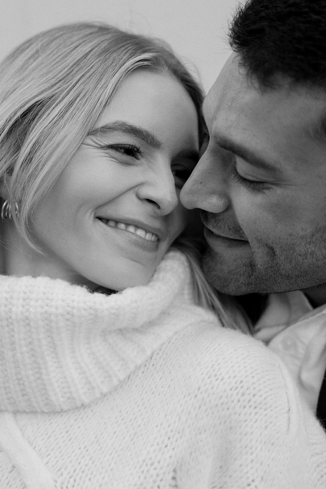 couples faces snuggle during intimate engagement shoot in the city