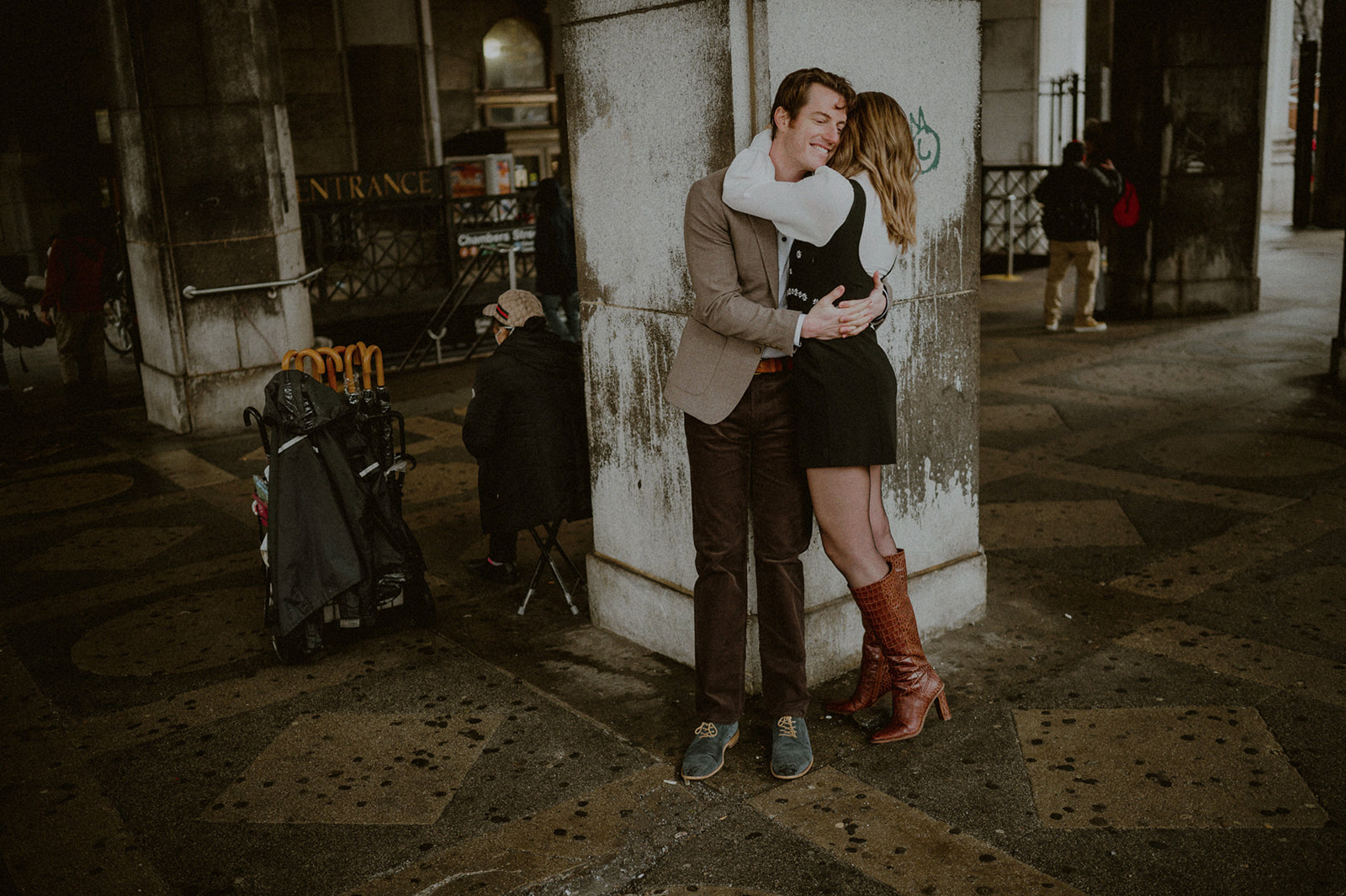 couple casually hugging by court house prior to their nyc elopement