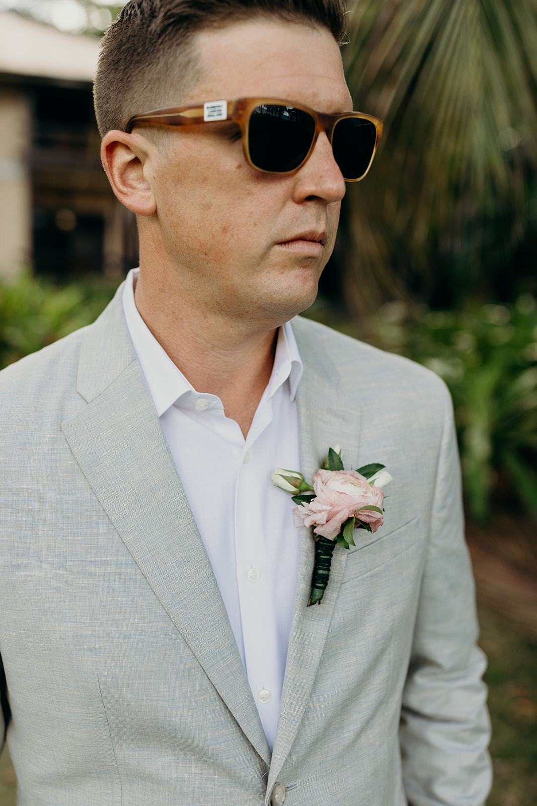 Groom wearing sunglasses at Caribbean destination wedding