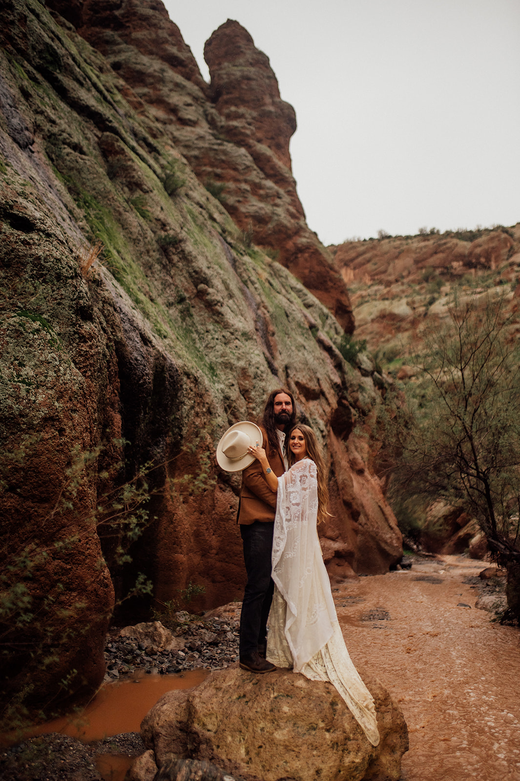 Couple posing in the rain in an Arizona desert canyon near Phoenix
