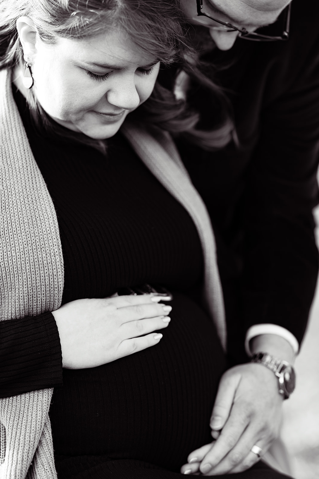 An intimate moment for a wife and husband that are expecting a newborn baby during their winter maternity session