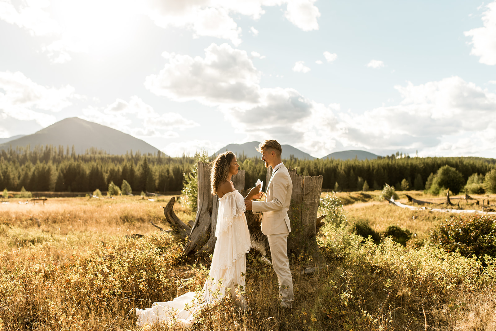 a couple who eloped in Glacier National Park say their vows as the sun sets behind the mountains