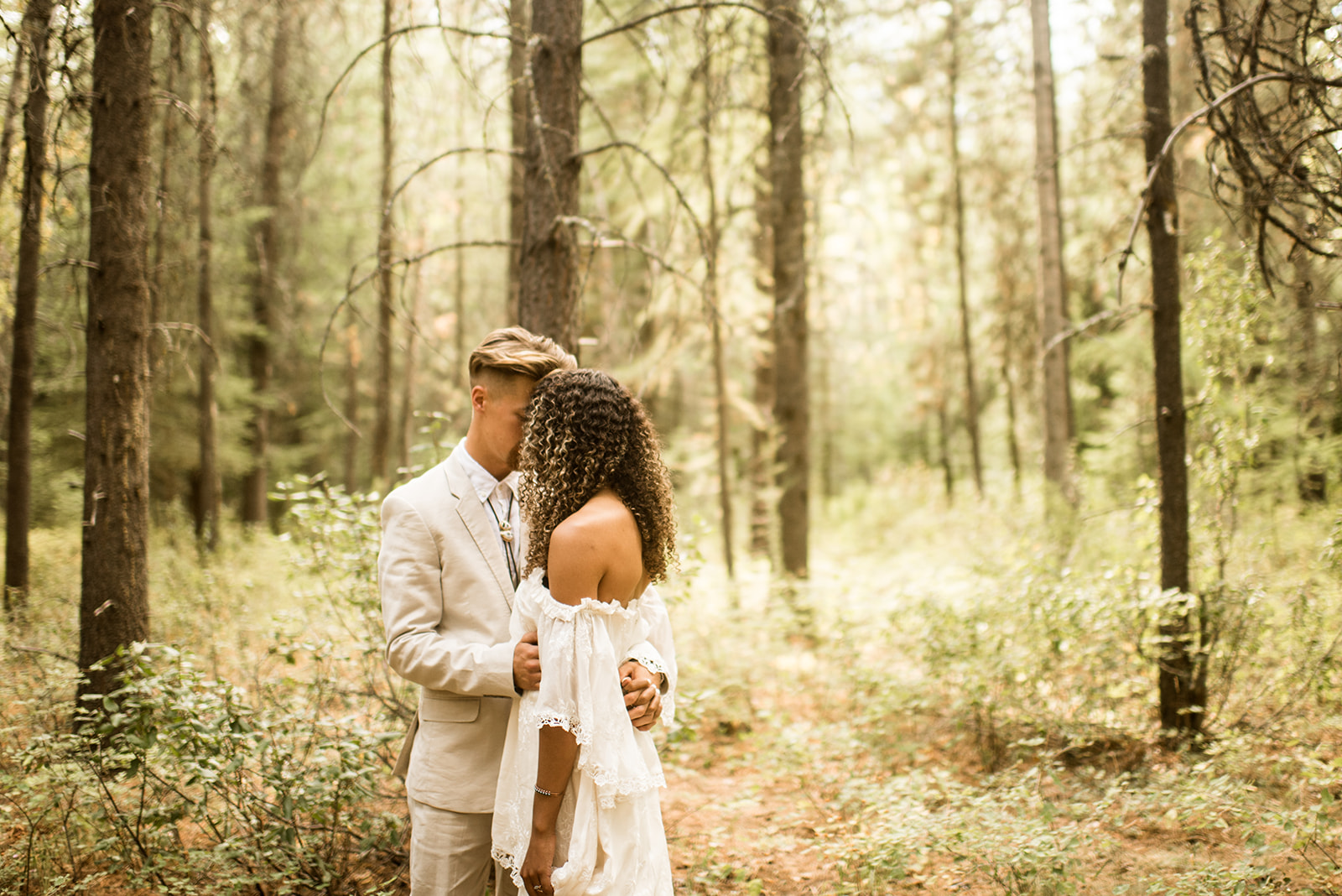 couple embraces in the Montana wilderness before their Glacier National Park elopement