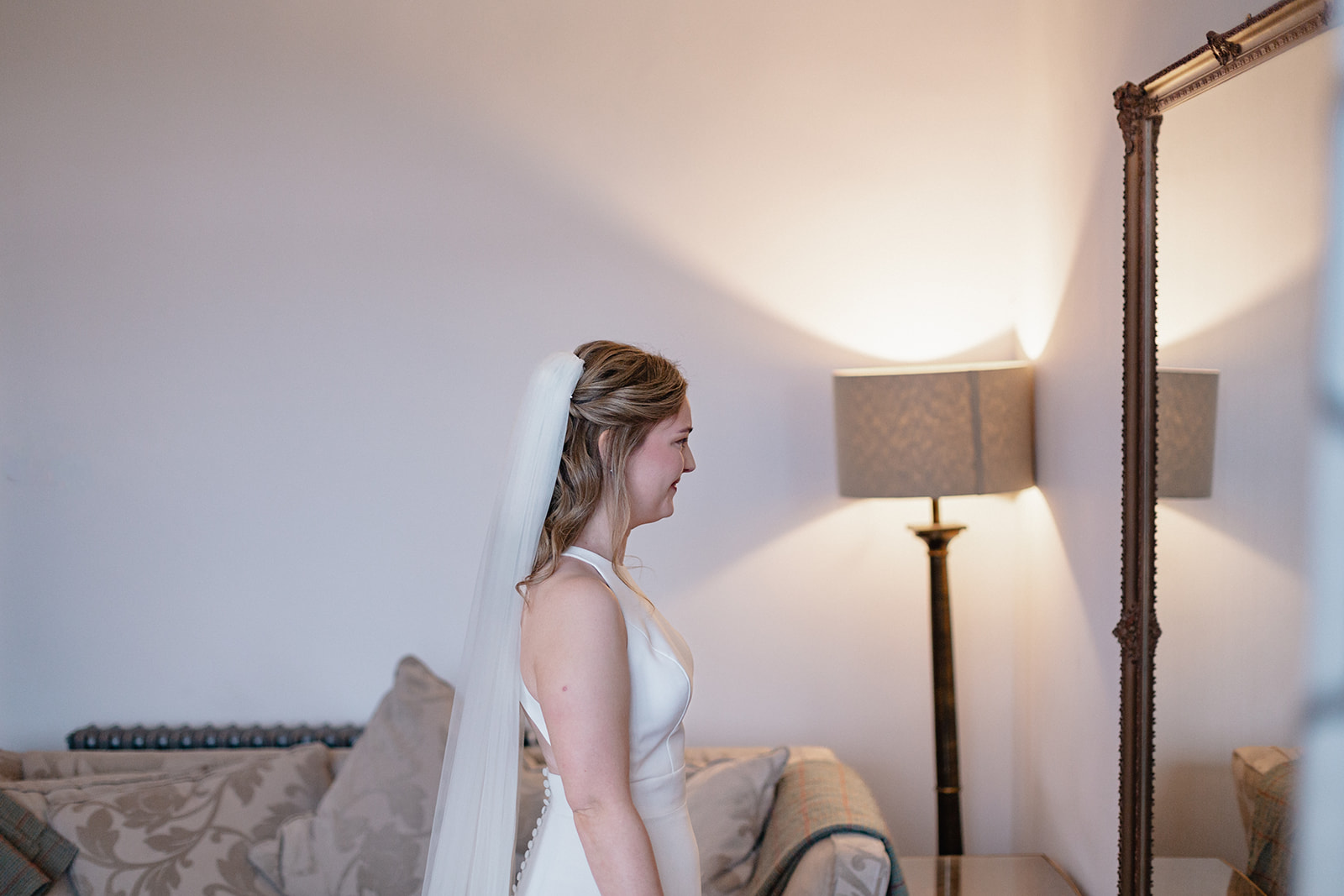 bride looking at herself in the mirror- Cairns Farm Estate