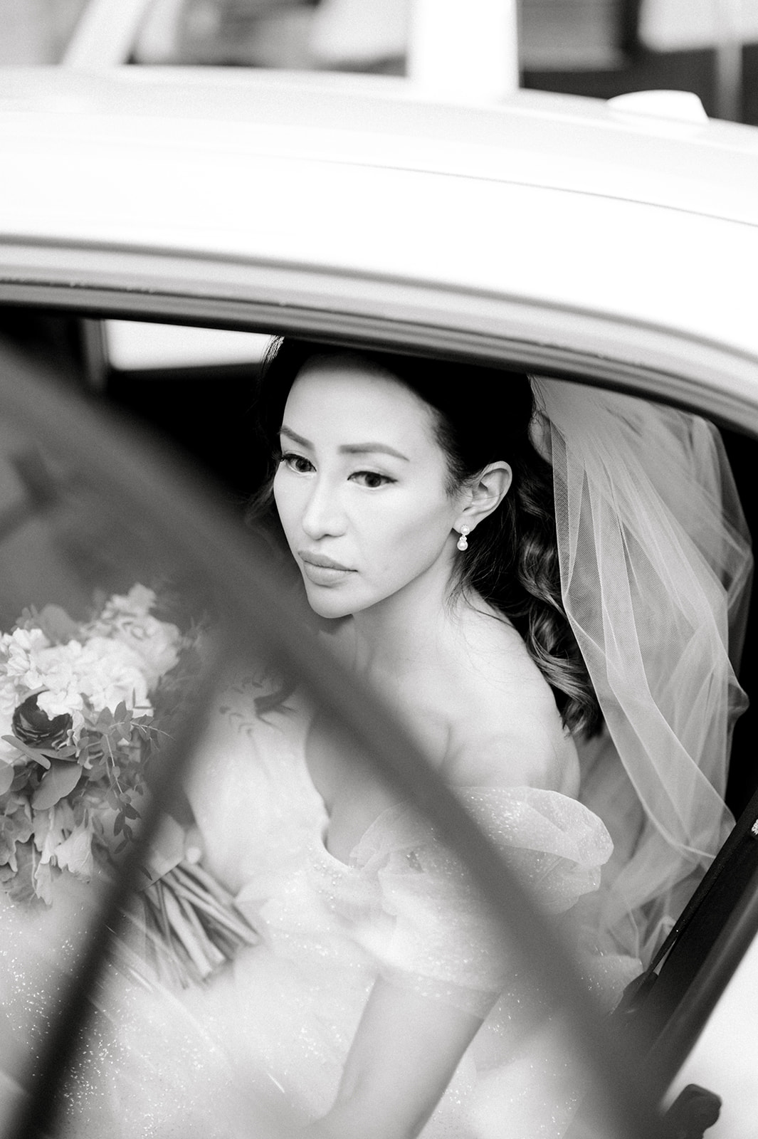 iconic luxury black and white photo of bride through car window at Winter Wedding at Philadelphia's Historic Union Trust