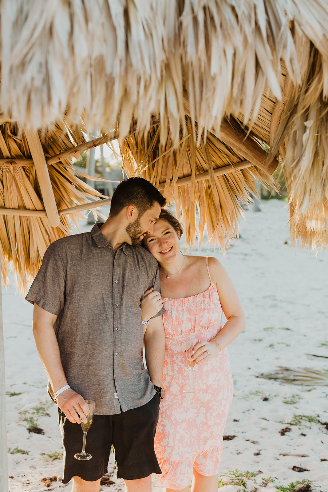 newly engaged couple under a palapa in Punta Cana