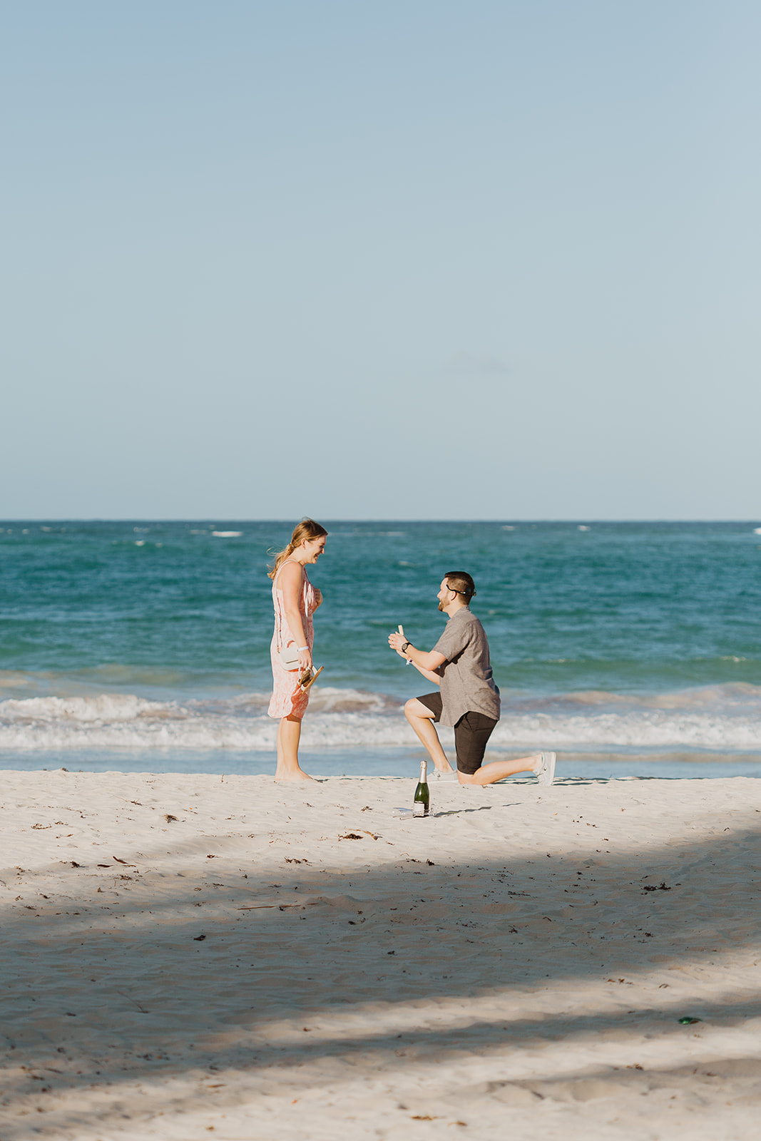 The moment of the proposal on the beach near the surf in Punta Cana Dominican Republic