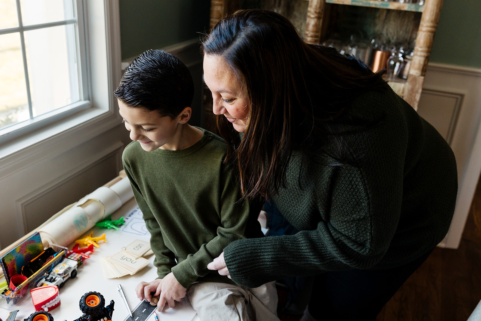 A mom and her son making art together during their family photo session