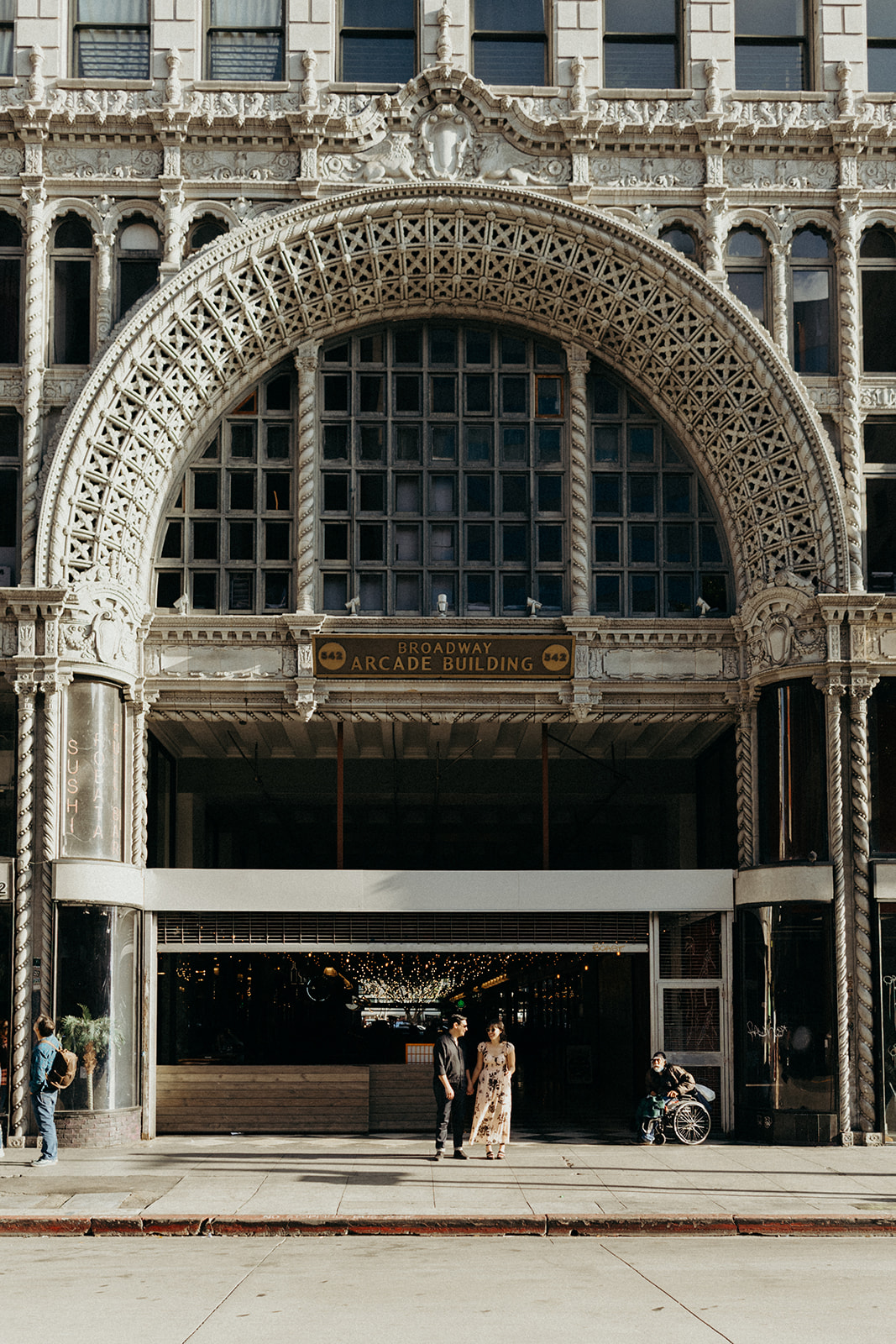 couple in front of Spring Arcade Building Los Angeles