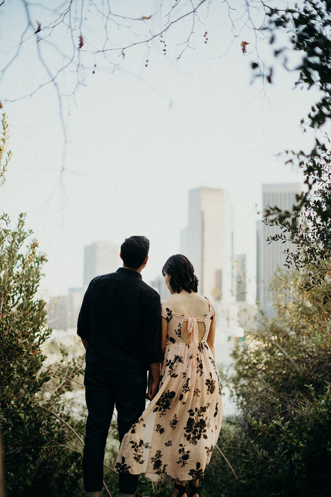 couple looking out at los angeles buildings
