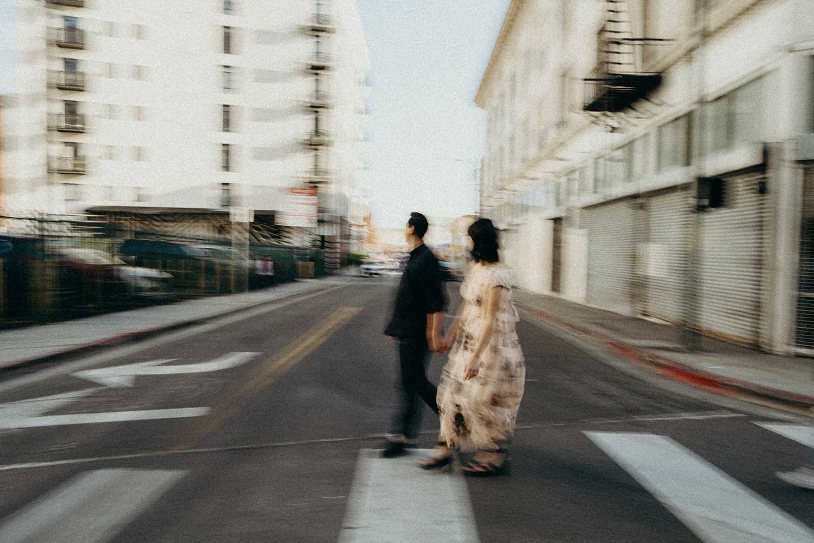 motion photo of couple crossing the street in los angeles