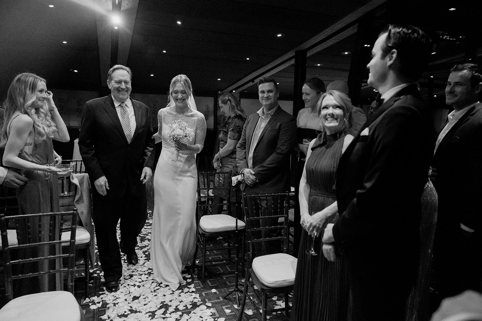 bride walks down aisle of white rose petals during Canlis ceremony