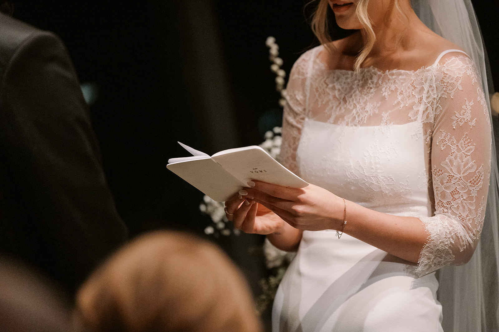 close on bride hold vow book during Canlis wedding ceremony