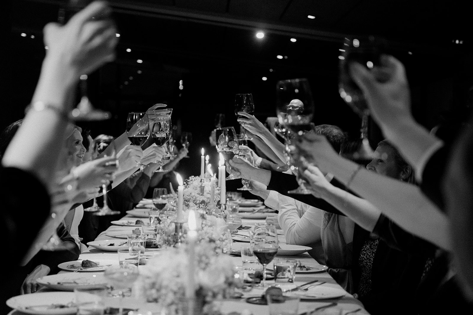 guests cheers with wine glasses during Canlis wedding reception