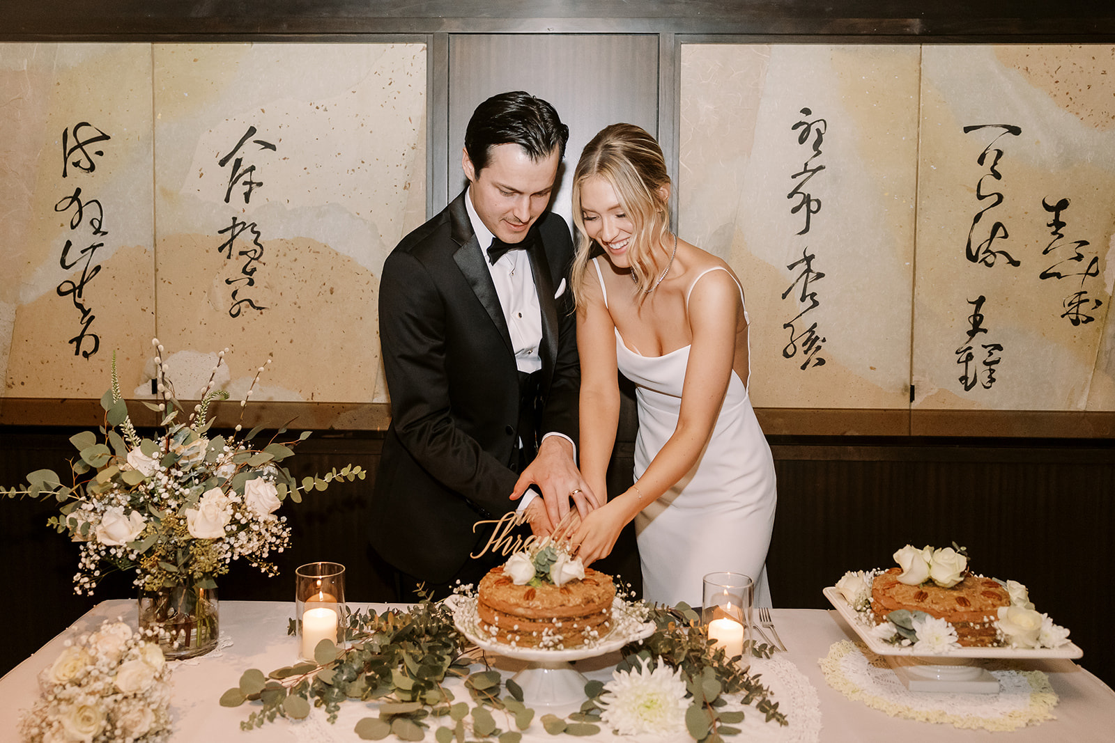 bride and groom cut cake at James Bond vibe wedding