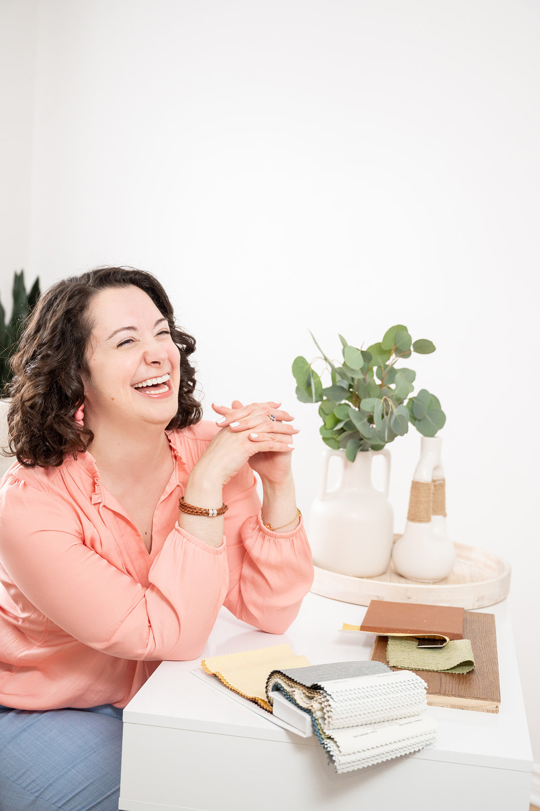 Interior designer laughing on her light and airy lifestyle branding photoshoot