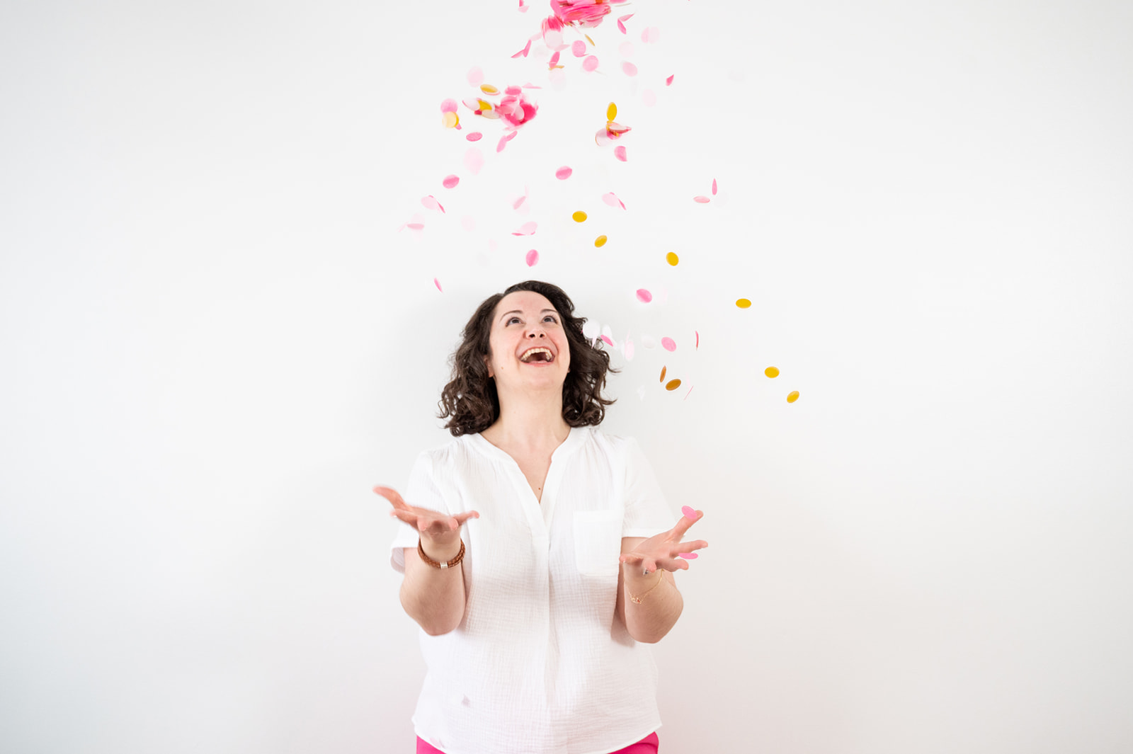 Woman throwing pink confetti in the air on her Ottawa lifestyle brand photo shoot