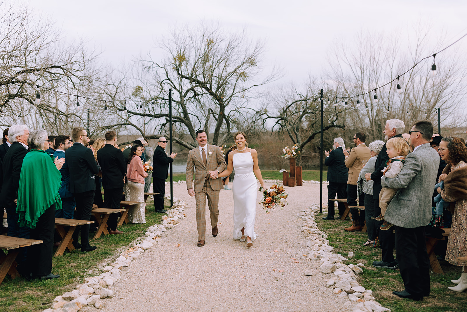 couple exits wedding ceremony at Camino Real Ranch greenhouse wedding venue