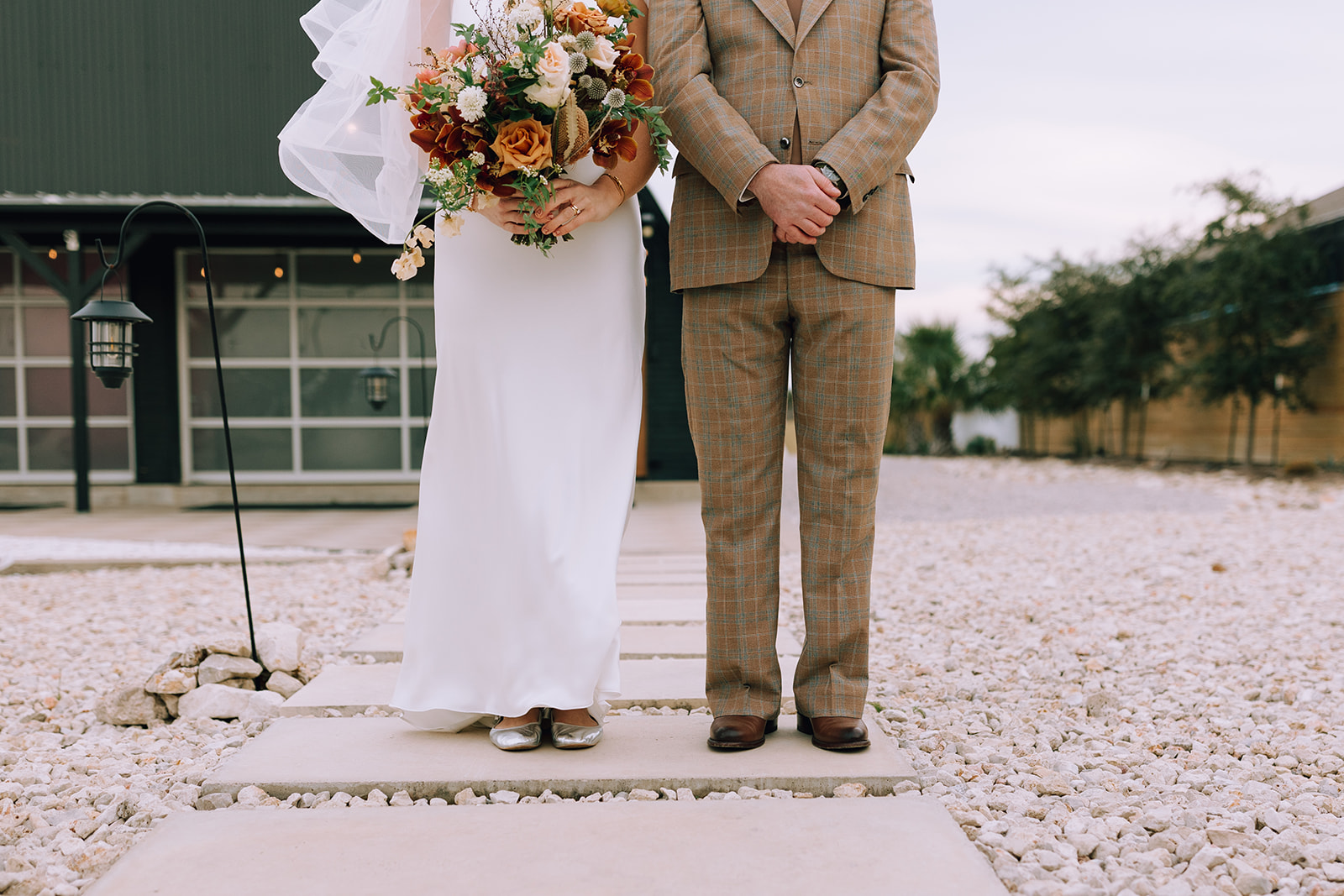 couple poses at Camino Real Ranch greenhouse wedding venue