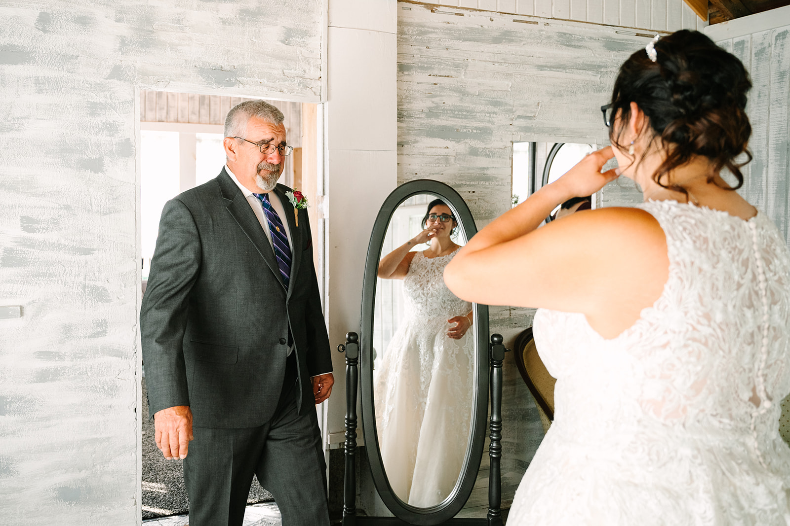 Bride and dad share an emotional moment together during their first look