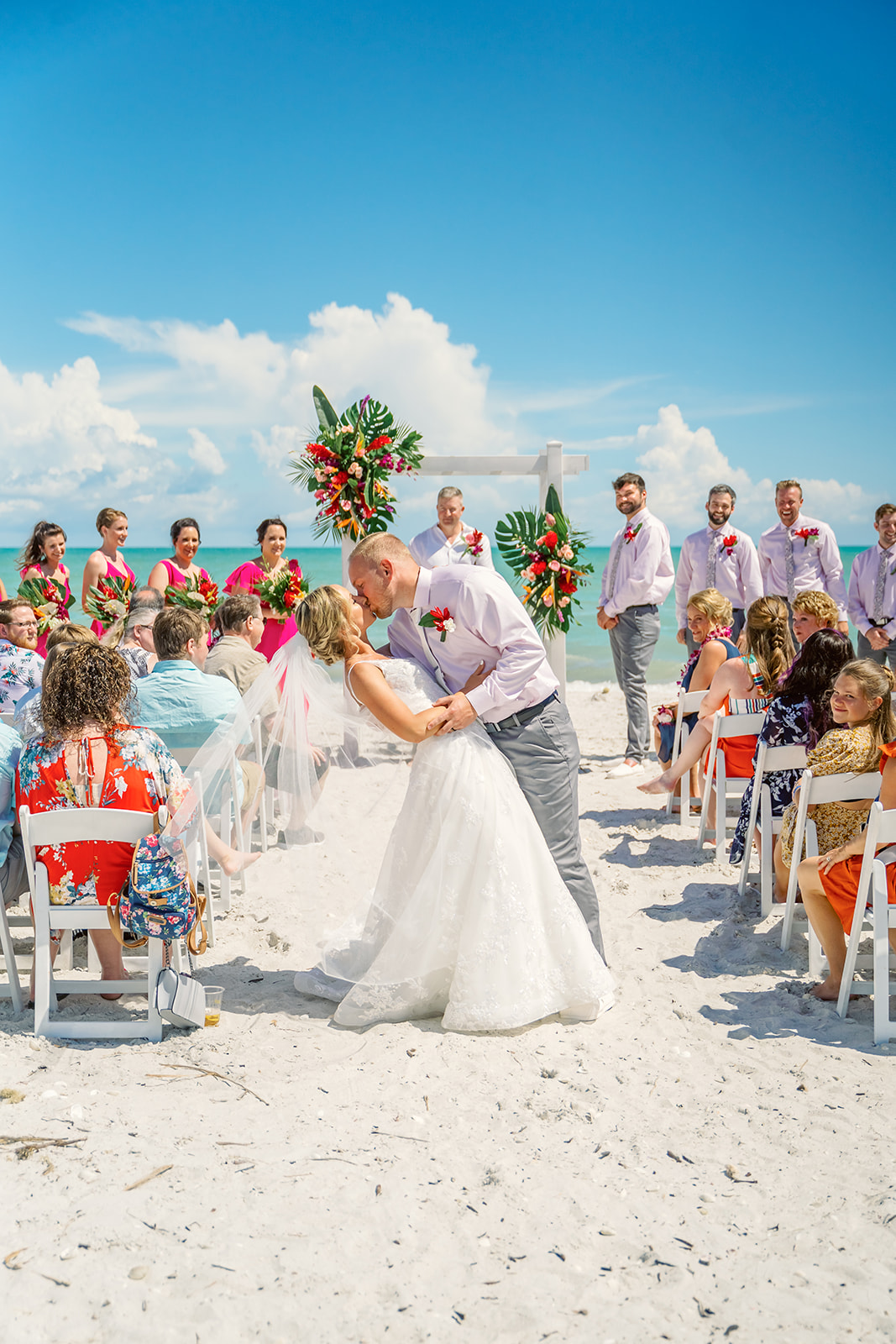 Bride and groom stop for a mid aisle kiss in sunny Sanibel, Florida for their destination wedding