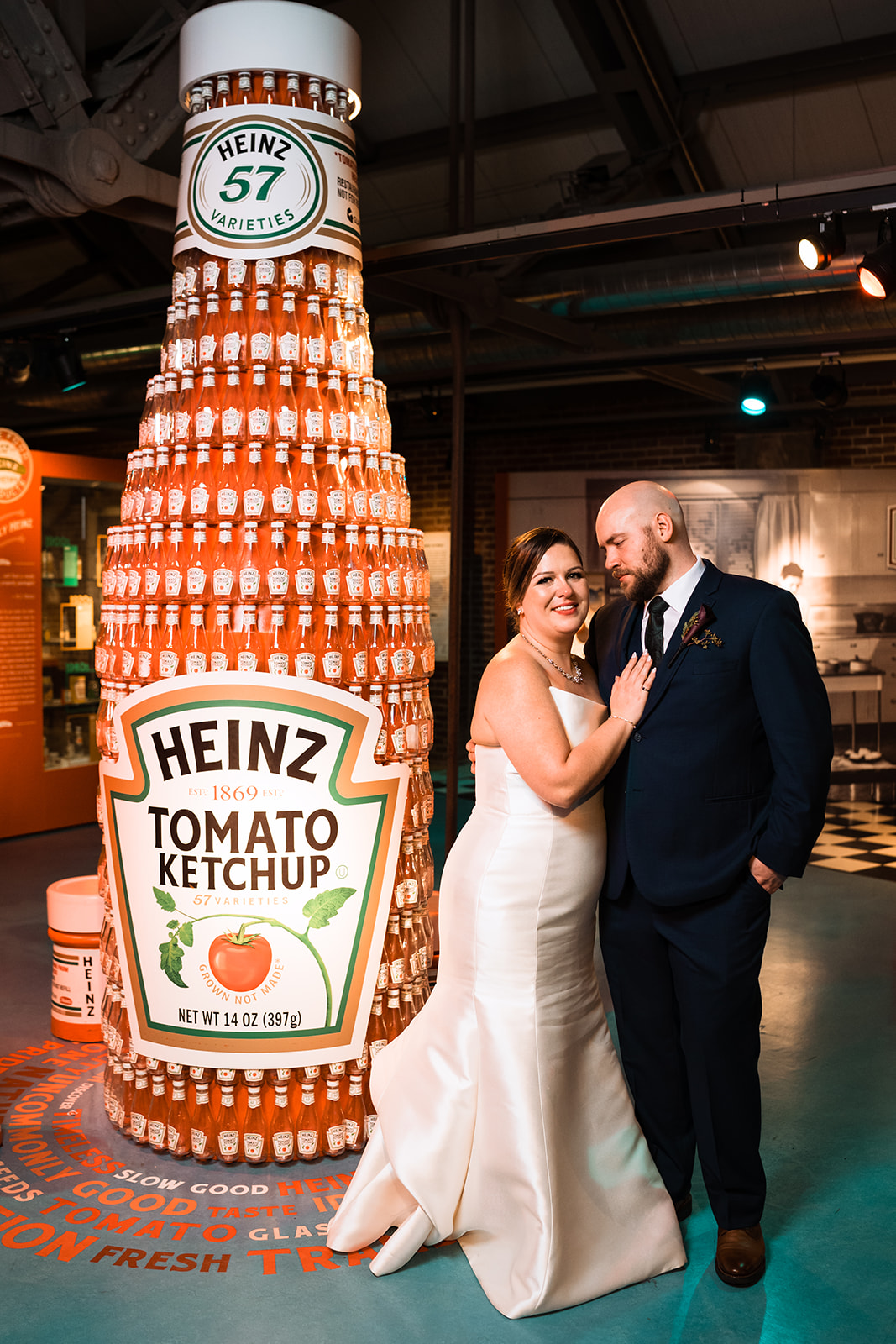 A wedding couple standing next to heinz ketchup  at a Heinz History Center Wedding