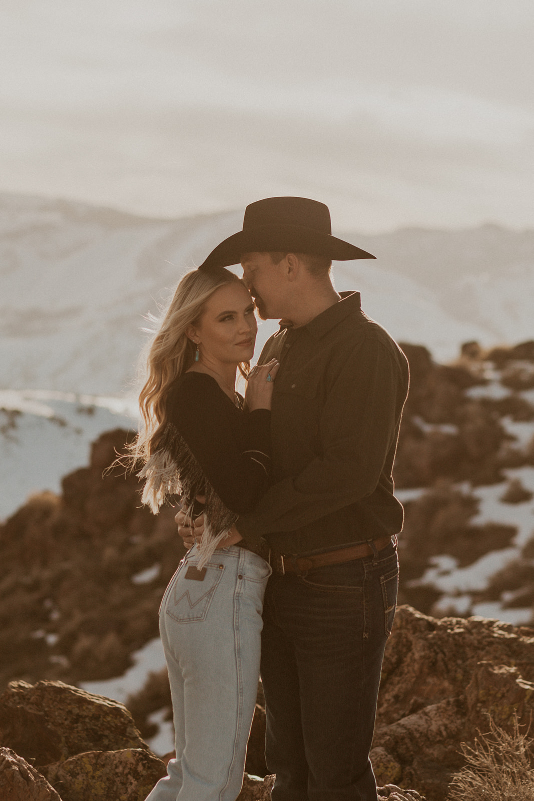 A couple above carson valley hugging and celebrating their engagement