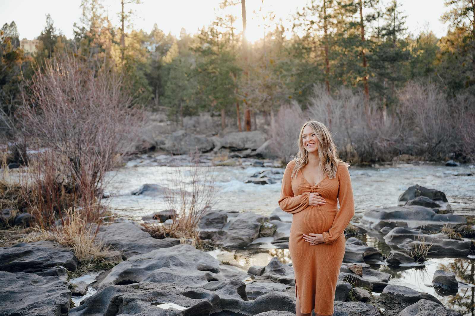 An expecting mama poses in front of the Deschutes River in Bend. 