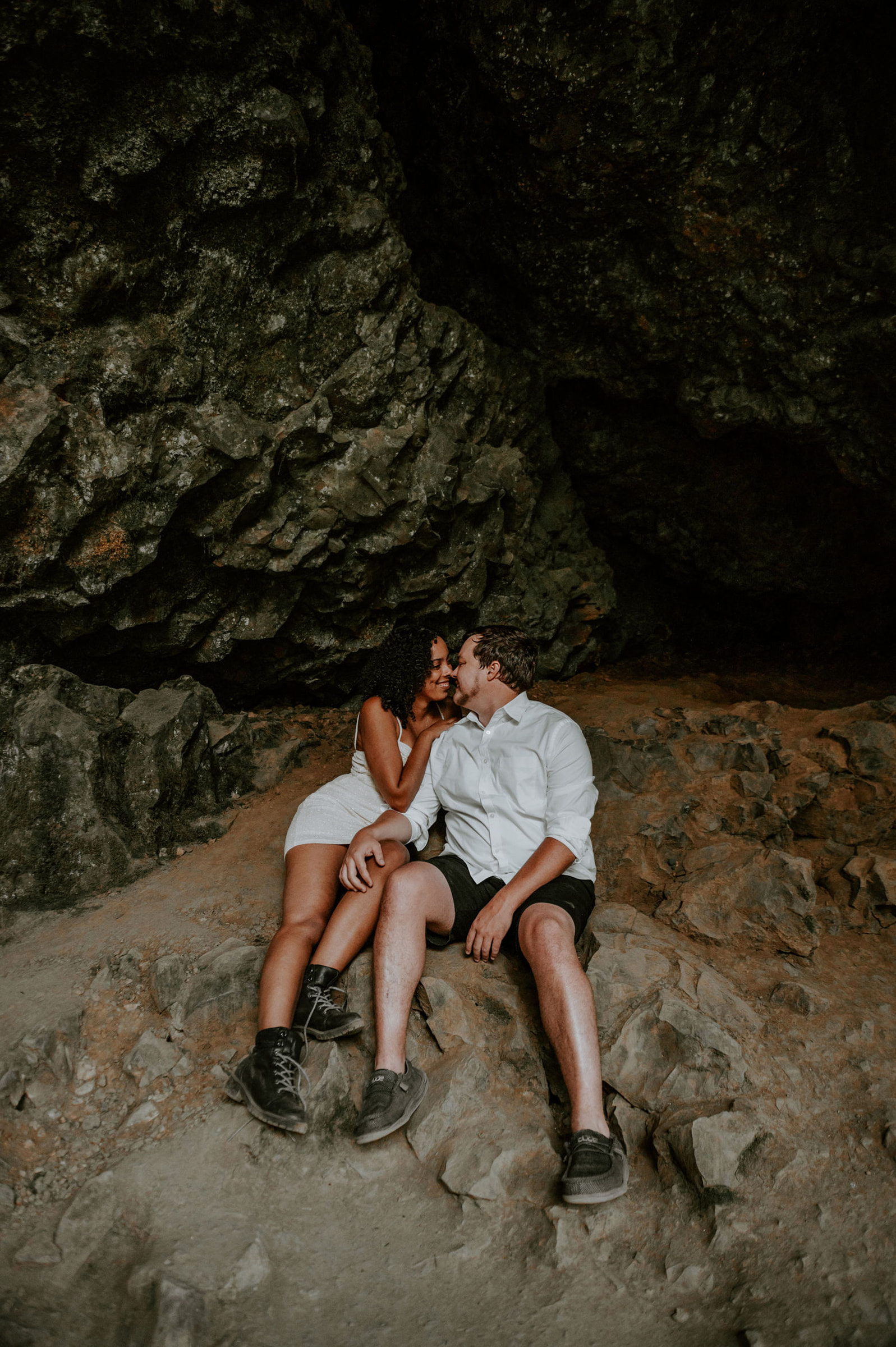 Couple nuzzled up inside a cave at Silver Falls State park for engagement photos