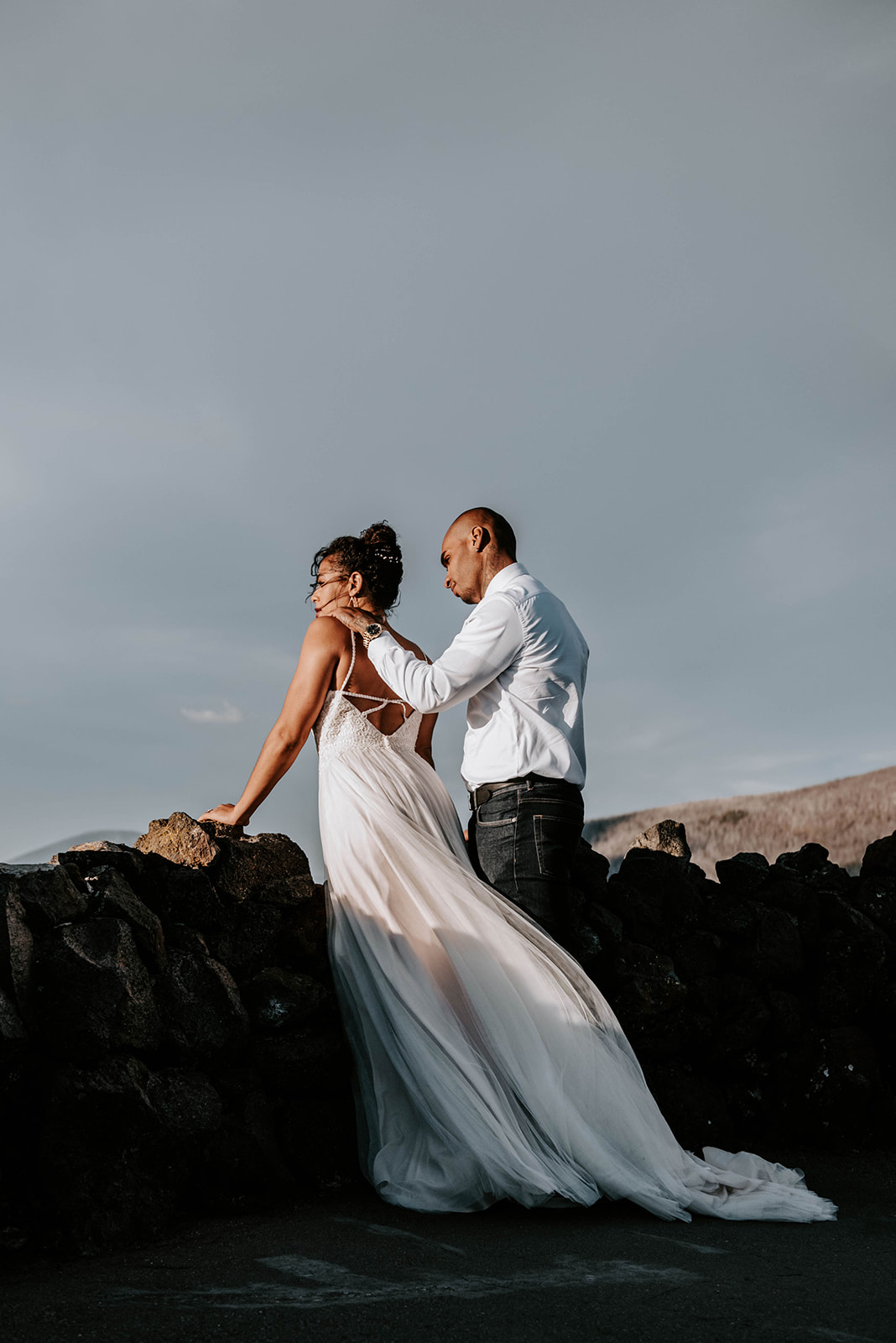 A bride and groom on top of the Oregon lava rock castle - Dee Wright Observatory