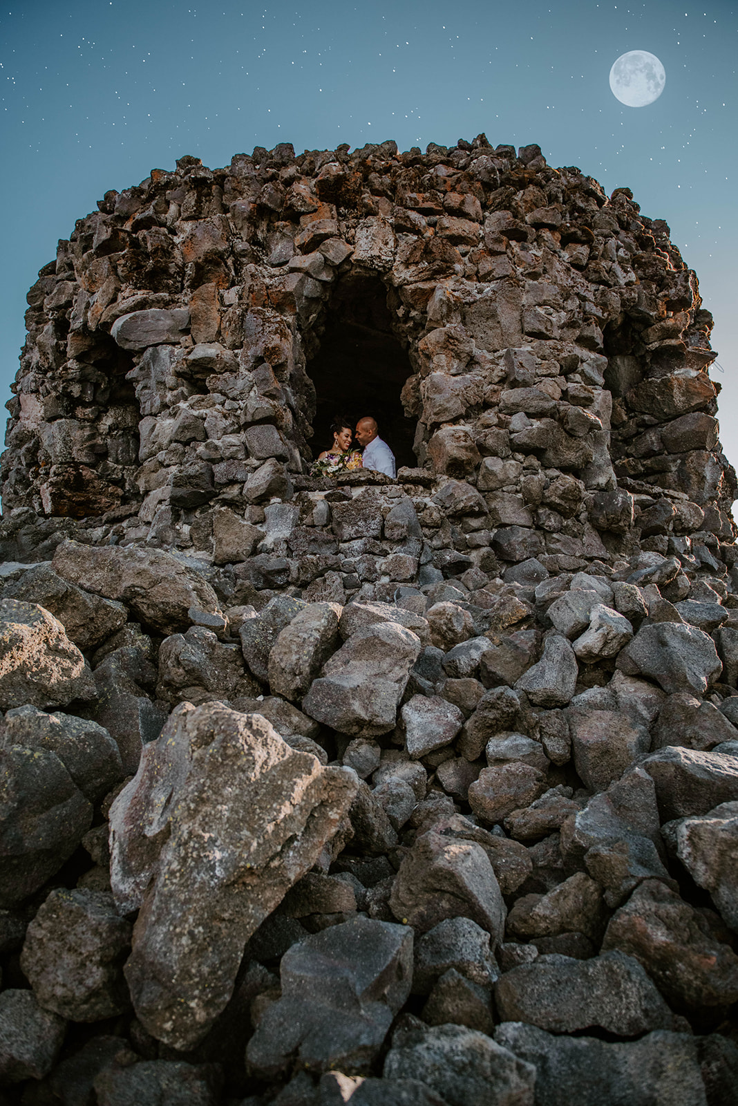 A couple who eloped in the lava castle, Dee Wright Observatory, just outside of Sisters, Oregon on a full moon.