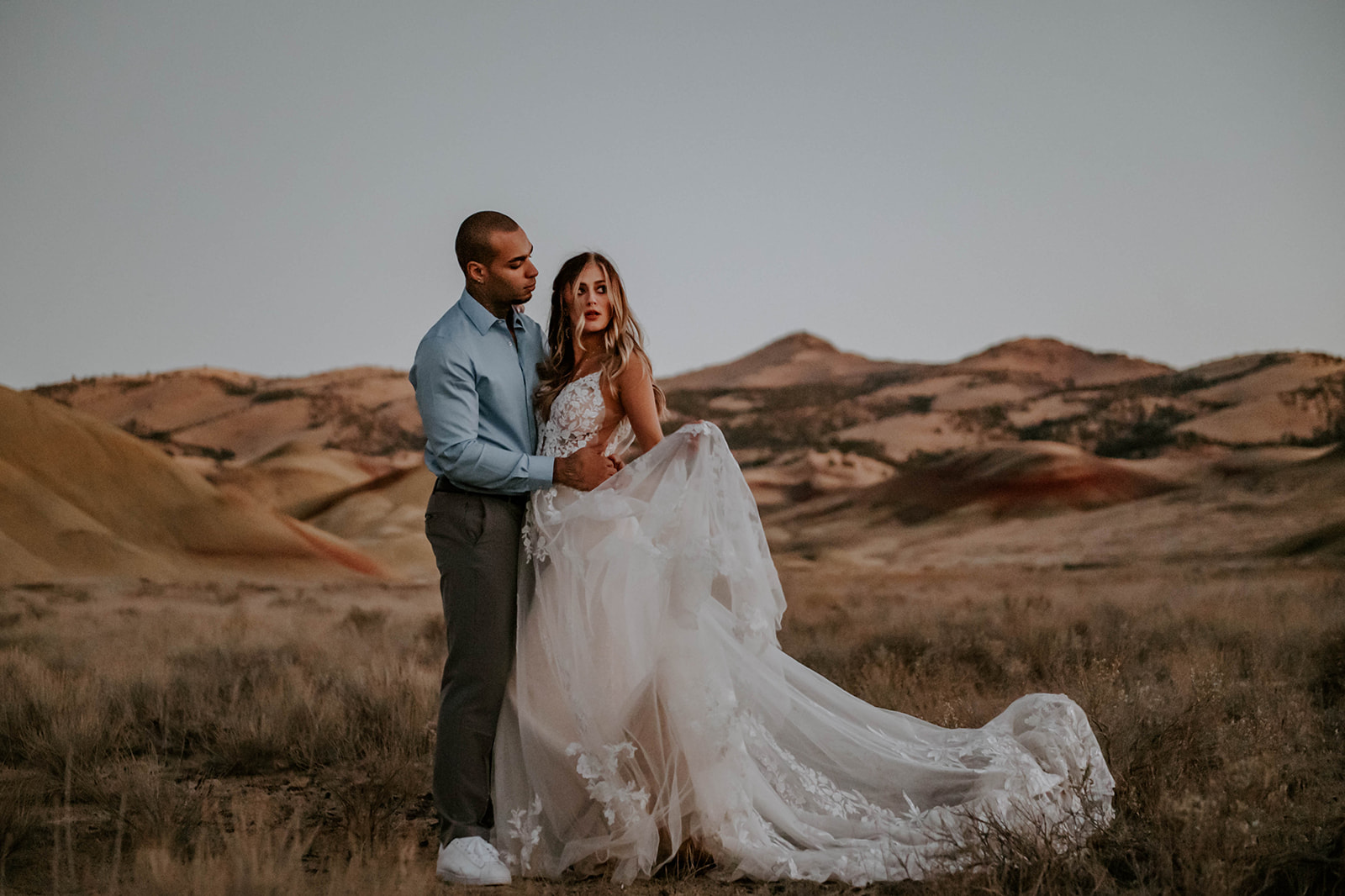 A bride and groom at dusk at the painted hills