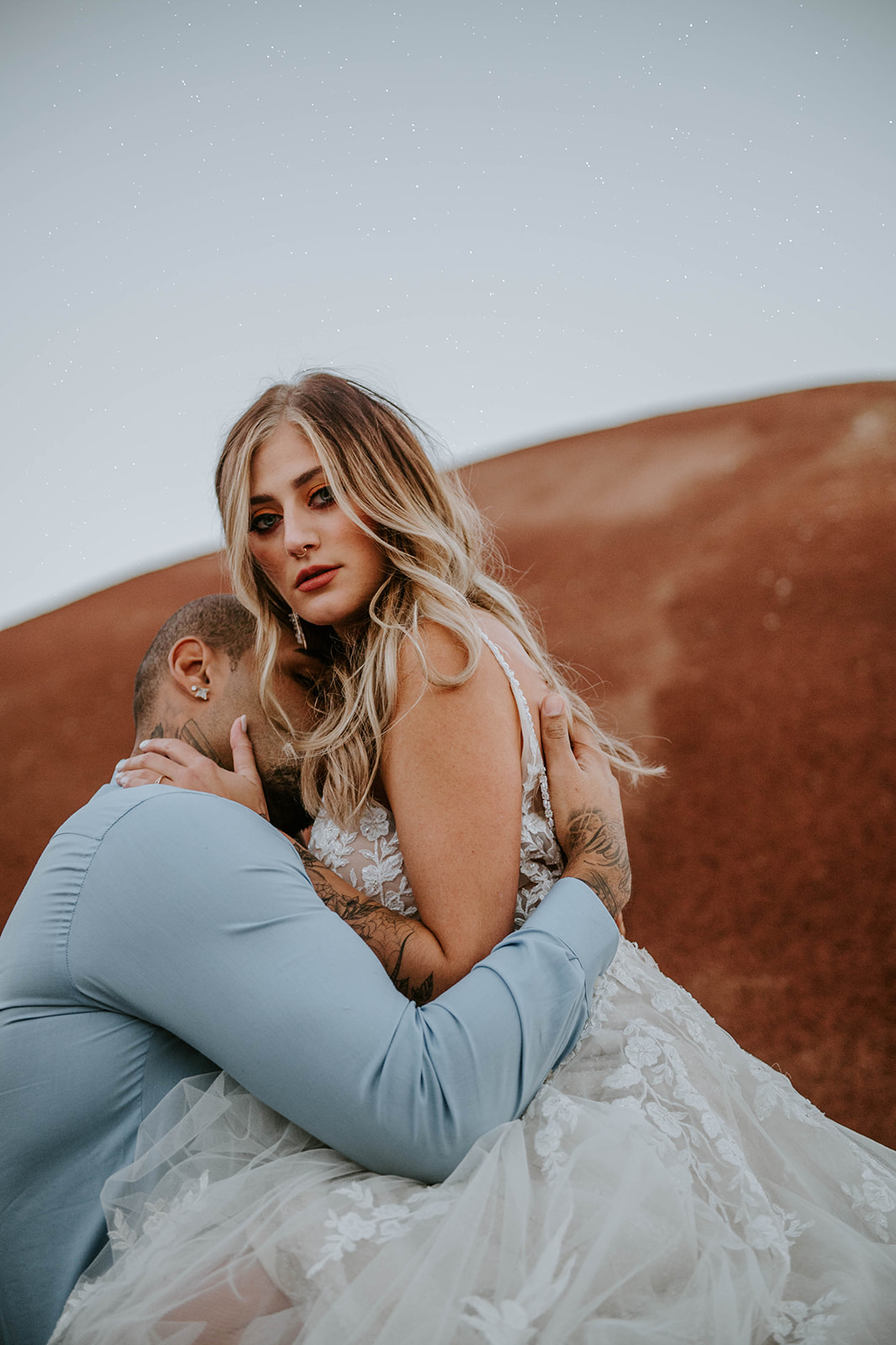 A bride straddling the groom at the Painted Hills