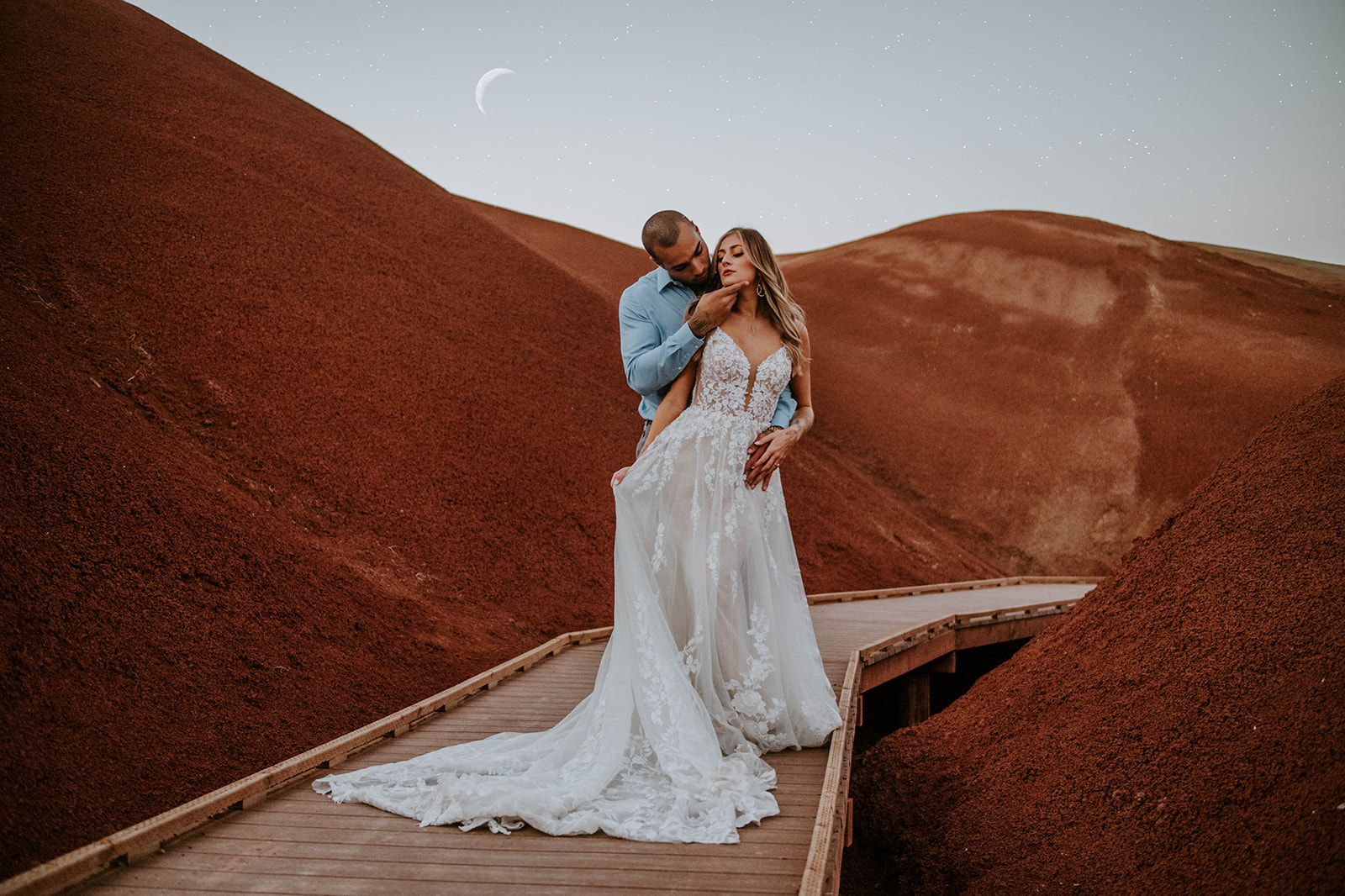 A couple who eloped on the bride at the Painted Hills at twilight