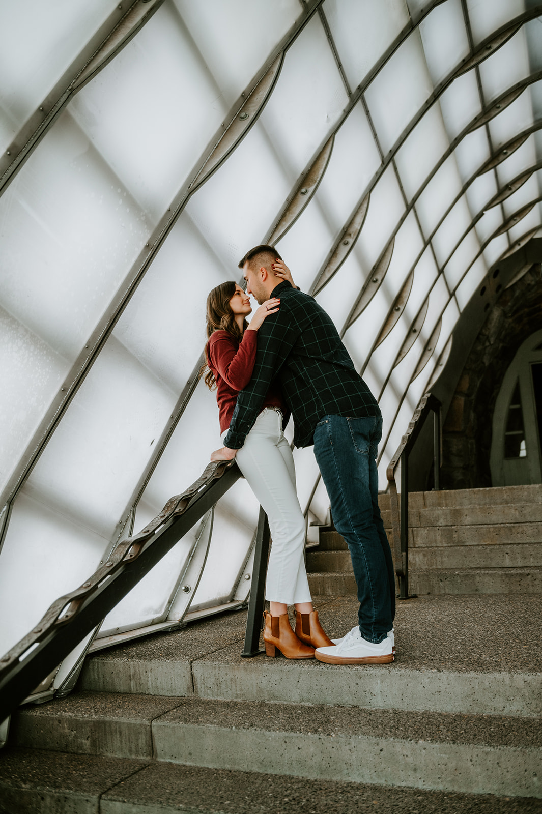Couple kissing inside the tunnel entrance of the timberline lodge for engagement photos