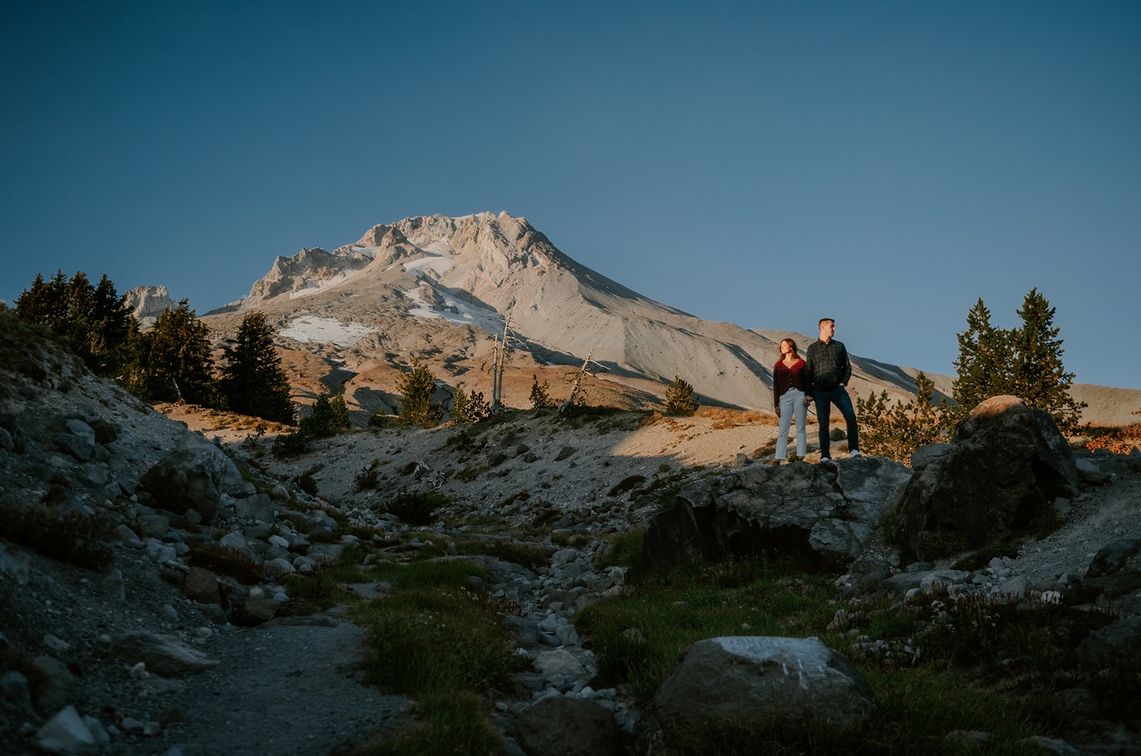 Couple posing in front of Mt. Hood for moody engagement photos
