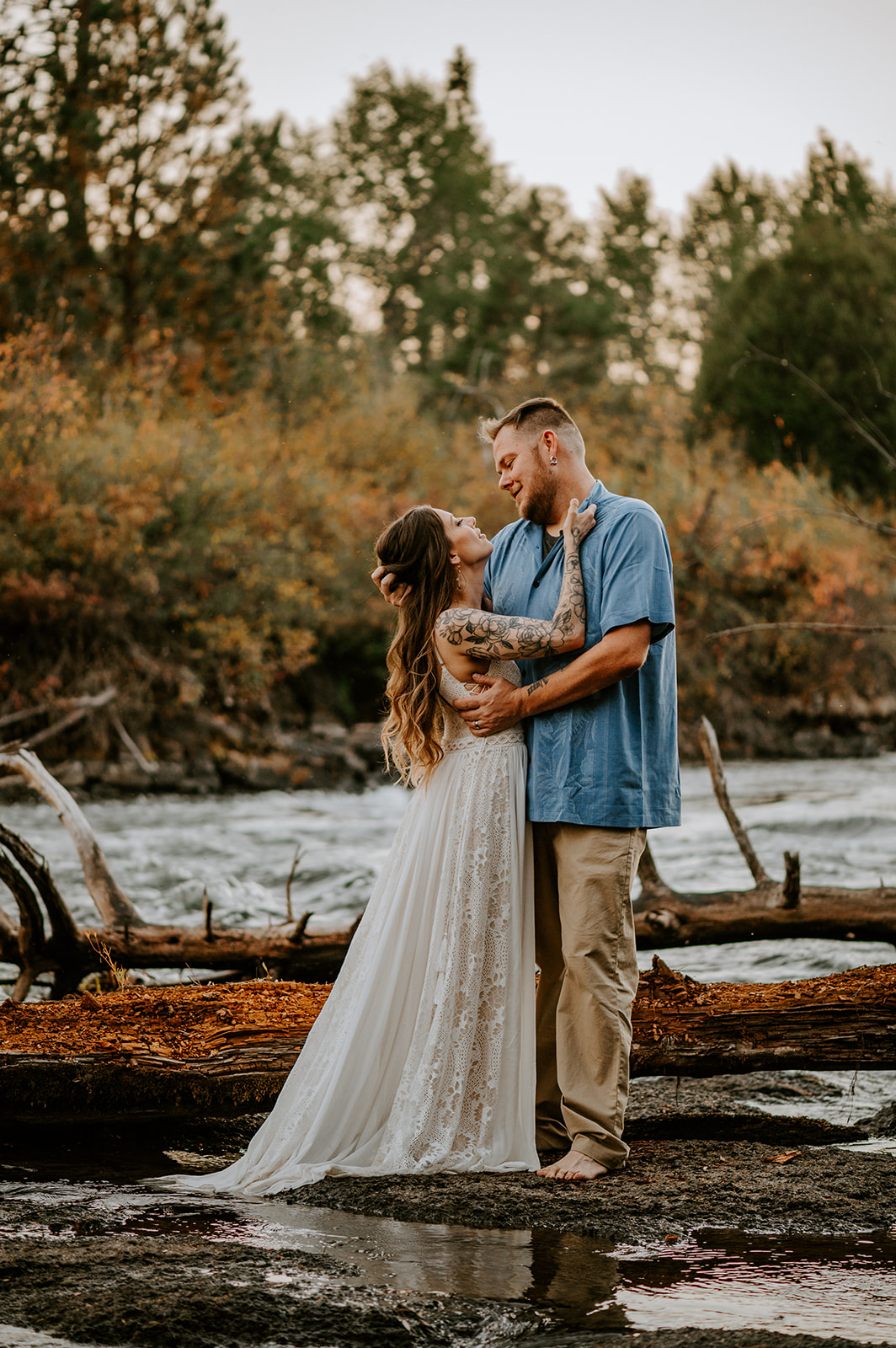Husband and wife embrace at vow renewal at Dillon falls in bend