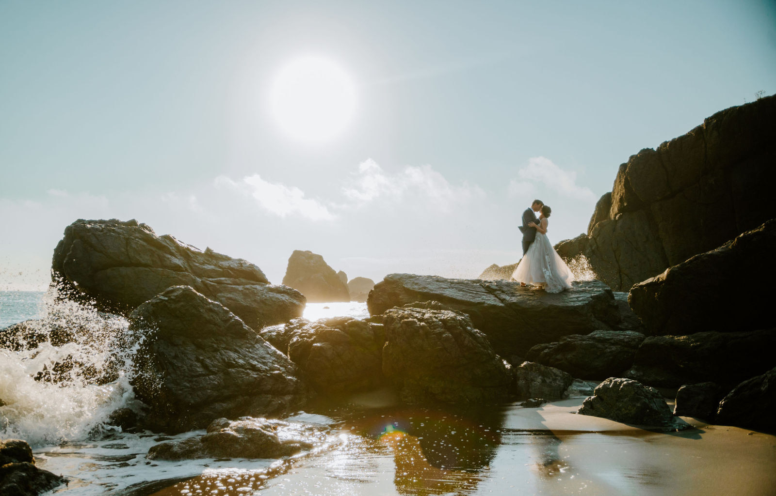 Bride and groom kissing as the waves crash at Samuel H Boardman State Park on the Oregon Coast lone ranch beach
