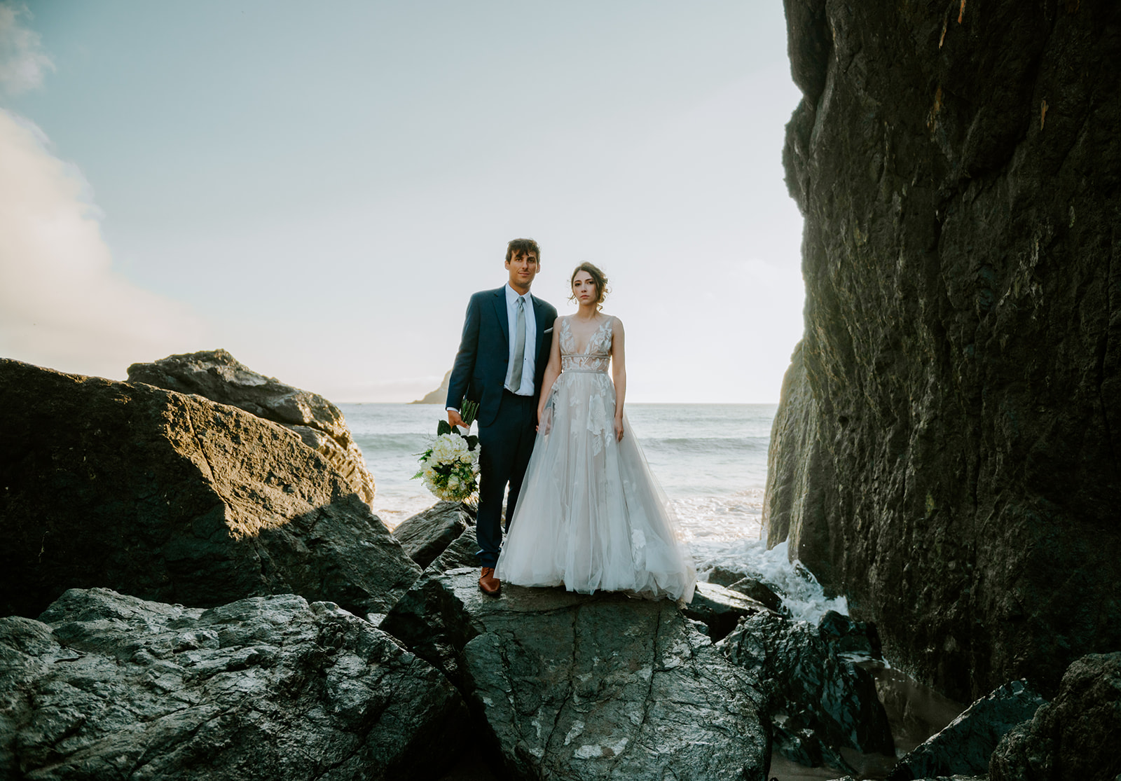 Bride and groom looking at the camera on Lone Ranch beach at Samuel H Boardman State Park on the Oregon Coast