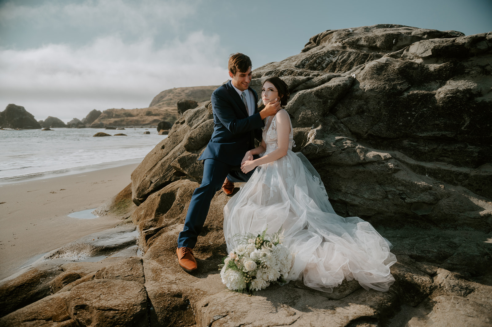Bride and groom on lone ranch beach at Samuel H Boardman State Park on the Oregon Coast