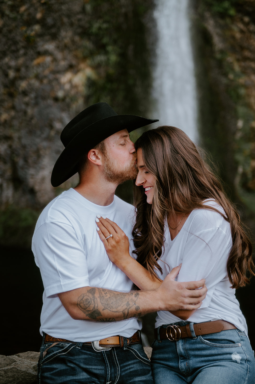 Casual couple engagement photos at the base of horsetail falls in oregon