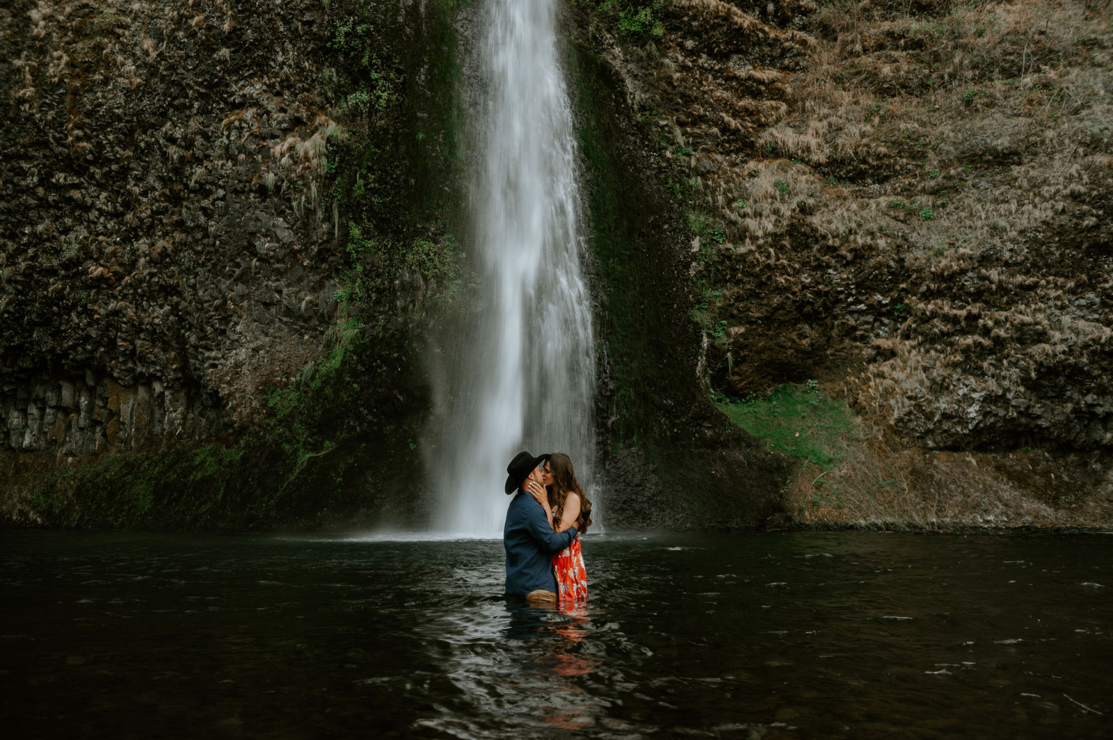 Couple kissing at the base of horsetail falls in the Colombia river gorge